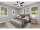Comfortable bedroom has a large window view, neutral walls, ceiling fan, and modern flooring at 1203 W 16Th St, Sanford, FL 32771