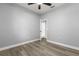 Bedroom featuring neutral walls, ceiling fan, hardwood floors, and closet storage at 1203 W 16Th St, Sanford, FL 32771