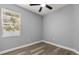 Bright bedroom featuring neutral walls, ceiling fan, hard wood floors and natural light at 1203 W 16Th St, Sanford, FL 32771