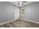 Bedroom featuring neutral walls, ceiling fan, hardwood floors, and closet storage at 1203 W 16Th St, Sanford, FL 32771