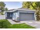 Charming one-story home with attached garage and blue exterior at 1203 W 16Th St, Sanford, FL 32771