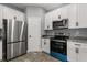 Stylish kitchen with stainless steel appliances and white cabinets at 1203 W 16Th St, Sanford, FL 32771