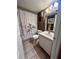 Bathroom featuring a vanity sink, a tile floor, and a shower with a curtain at 130 Jasmine Woods Ct # 3D, Deltona, FL 32725