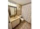 Standard bathroom featuring tiled floors, a single sink vanity, and a shower tub combo with patterned curtain at 130 Jasmine Woods Ct # 3D, Deltona, FL 32725