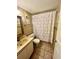 Bathroom with tile flooring, vanity sink, and shower with white patterned curtain at 130 Jasmine Woods Ct # 3D, Deltona, FL 32725