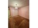 Bedroom with pink walls featuring chandelier lighting, closet and carpeting at 130 Jasmine Woods Ct # 3D, Deltona, FL 32725