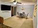 Bright dining area featuring a chandelier, and living space with a wall-mounted TV at 130 Jasmine Woods Ct # 3D, Deltona, FL 32725