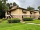 Tan two-story home with dark shutters and a lush green lawn at 130 Jasmine Woods Ct # 3D, Deltona, FL 32725