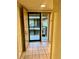 Tiled hallway with access to the outside balcony, front door, and closet space at 130 Jasmine Woods Ct # 3D, Deltona, FL 32725