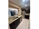 Open concept kitchen view of granite countertops, stainless steel appliances and open dining space at 130 Jasmine Woods Ct # 3D, Deltona, FL 32725