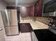 Modern kitchen with stainless steel refrigerator, mosaic backsplash, and granite countertops at 130 Jasmine Woods Ct # 3D, Deltona, FL 32725