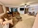 Open living room featuring comfortable seating, a ceiling fan, and sliding glass doors to the outside at 130 Jasmine Woods Ct # 3D, Deltona, FL 32725