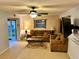 A cozy living room with a ceiling fan, comfortable sofas, and a side access sliding glass door at 130 Jasmine Woods Ct # 3D, Deltona, FL 32725