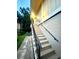 Staircase leads to the entrance of a tan and well-lit home at 130 Jasmine Woods Ct # 3D, Deltona, FL 32725