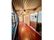 Enclosed sunroom with paneled ceiling, wood floors, ceiling fans and sliding glass doors at 130 Jasmine Woods Ct # 3D, Deltona, FL 32725