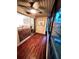 Enclosed sunroom with paneled ceiling, wood floors, ceiling fan and sliding glass doors at 130 Jasmine Woods Ct # 3D, Deltona, FL 32725