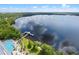 Breathtaking aerial view features a resort-style pool, lakeside dock and lush green landscaping for peaceful community living at 13427 Blue Heron Beach Dr # 1907, Orlando, FL 32821