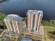 Aerial of condo towers with great location and amenities featuring a pool, convenient parking, and water views at 13427 Blue Heron Beach Dr # 1907, Orlando, FL 32821