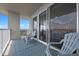 Comfortable balcony seating area with sliding door access to the indoor living space at 13427 Blue Heron Beach Dr # 1907, Orlando, FL 32821