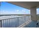 Enjoy stunning waterfront views from this spacious balcony featuring a stylish outdoor rug and comfortable seating at 13427 Blue Heron Beach Dr # 1907, Orlando, FL 32821