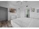 Comfortable bedroom featuring a wall-mounted TV and convenient access to the en-suite bathroom at 13427 Blue Heron Beach Dr # 1907, Orlando, FL 32821