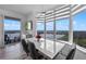 Elegant dining area featuring modern furnishings, floor-to-ceiling windows with picturesque views, and seamless access to balcony at 13427 Blue Heron Beach Dr # 1907, Orlando, FL 32821