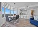 Bright, airy dining area with modern table and expansive windows showcasing scenic views, seamlessly connected to the kitchen at 13427 Blue Heron Beach Dr # 1907, Orlando, FL 32821