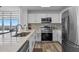 Modern kitchen with stainless steel appliances, white cabinets, and granite countertops at 13427 Blue Heron Beach Dr # 1907, Orlando, FL 32821