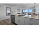 Open kitchen with stainless appliances, stone counters, and a view of the living room at 13427 Blue Heron Beach Dr # 1907, Orlando, FL 32821