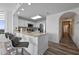 Modern kitchen features stainless steel appliances, breakfast bar seating, and easy access to the hallway and living areas at 13427 Blue Heron Beach Dr # 1907, Orlando, FL 32821