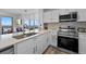 Bright kitchen featuring stainless steel appliances, stone countertops, and a view at 13427 Blue Heron Beach Dr # 1907, Orlando, FL 32821