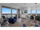 Cozy living room and dining area boasts balcony access, plush seating, and picturesque waterfront views for relaxed entertaining at 13427 Blue Heron Beach Dr # 1907, Orlando, FL 32821