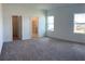 Bright, carpeted bedroom with natural light and ensuite bathroom and walk-in closet entries at 1392 Dalkeith Cv, Sanford, FL 32771