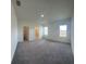 Spacious bedroom featuring neutral carpet, ample natural light, and ensuite bathroom and closet entries at 1392 Dalkeith Cv, Sanford, FL 32771