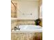 Elegant soaking tub with tiled surround and chrome fixtures, perfect for relaxation at 1474 Lake Side Ave, Davenport, FL 33837