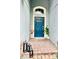 Inviting entryway with a blue front door, decorative plants, and stylish decor at 1474 Lake Side Ave, Davenport, FL 33837