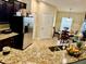 The kitchen features granite counters, stainless steel appliances, and a breakfast nook at 1474 Lake Side Ave, Davenport, FL 33837