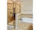 Stunning primary bathroom with a glass-enclosed shower and a luxurious soaking tub at 1474 Lake Side Ave, Davenport, FL 33837