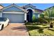 Charming home with a two-car garage, red brick driveway, and well-maintained landscaping at 1474 Lakeside Ave, Davenport, FL 33837