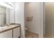 Simple bathroom with functional vanity, framed mirror, tiled floor, and walk-in shower at 149 Emeraldview Ave, Davenport, FL 33897