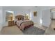 Cozy bedroom featuring neutral carpet, two windows, and an ensuite bathroom with a granite vanity at 149 Emeraldview Ave, Davenport, FL 33897