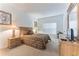Tranquil bedroom featuring neutral carpet, a window, and a closet with wood grain furnishings at 149 Emeraldview Ave, Davenport, FL 33897