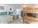 Comfortable bedroom with twin beds and a wooden bunk bed, perfect for or guests at 149 Emeraldview Ave, Davenport, FL 33897