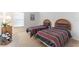 Bright bedroom with two beds and a nightstand under a window at 149 Emeraldview Ave, Davenport, FL 33897