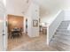 The dining area features neutral tile flooring, chandelier, and stairs to the second floor at 149 Emeraldview Ave, Davenport, FL 33897