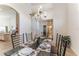 The dining area features neutral tile flooring, chandelier, and furniture ready for hosting dinner parties at 149 Emeraldview Ave, Davenport, FL 33897