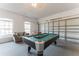 Game room complete with pool table, foosball, and sofa with great natural light at 149 Emeraldview Ave, Davenport, FL 33897