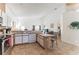 Well-equipped kitchen with white appliances, breakfast bar, and views into the living area at 149 Emeraldview Ave, Davenport, FL 33897