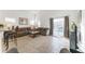 Inviting living room featuring tile floors, comfortable seating, and sliding glass doors to the pool area at 149 Emeraldview Ave, Davenport, FL 33897