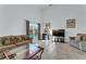 Bright living room with tile flooring, comfortable seating, and sliding glass doors to the outdoor pool at 149 Emeraldview Ave, Davenport, FL 33897